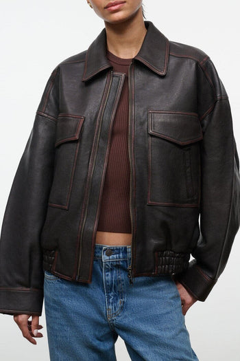 Distressed brown leather jacket with collar, zip front, and flap chest pockets