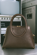 <p>The Naomi Satchel's rounded handle and body shape takes inspiration from Maude's silhouette. </p>
