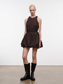 Dark brown sleeveless mini dress with high neckline, cinched waist, puffed skirt detail
