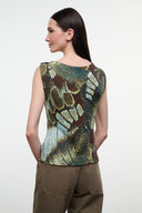 Back view of sleeveless printed top with green, gold, and brown butterfly pattern