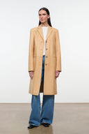 Tan leather long coat with notched lapels, single-breasted buttons, side pockets.