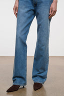 Dark brown ankle boot with pointed toe and kitten heel, worn with jeans