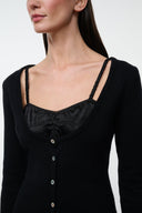 Black cashmere sweater with square neckline, strap trim, and button front