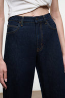 LEO high-rise indigo jeans waistband detail with belt loops and button