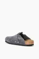 A single gray suede clog slipper with a black sole and a natural cork footbed, shown from a side profile against a plain white background.