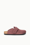 A single clog-style mule shoe in dusty rose suede with a hook-and-loop strap, cork footbed, and black outsole, shown in profile against a plain white background.