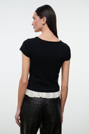 Black knit top with scoop back and ivory ruffled hem trim