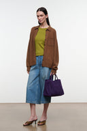 Amethyst purple suede satchel with top handles and shoulder strap, side view