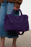 Amethyst purple suede tote satchel with rounded handles and long crossbody strap