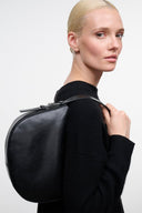 LEVI black leather shoulder bag with short handle and adjustable strap, side view
