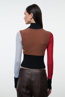 Back view color-block mock-neck long-sleeve top in brown, black, red, and light blue