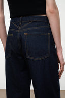 GUS relaxed jeans in dark indigo, close-up of waistband and stitched pocket