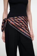 Silk scarf with multicolor geometric stripe pattern, tied sash across waist