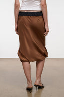 Silk midi skirt with dark brown gathered back, black elastic waistband, soft draped folds