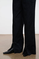 Black snake-texture flat ankle boots with pointed toe, low heel, side view.