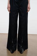 Black snake-texture flat ankle boots with pointed toe and low heel, front view.