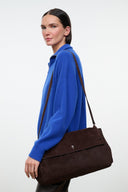 Oversized espresso-brown shoulder bag with long strap and front flap closure