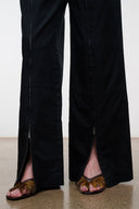 Black wide-leg pants with side slit and zippered ankle openings