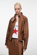 Cigar brown jacket with snap placket, stand collar, and patch pockets; worn over top