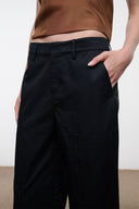 Black pants with belt loops and front pockets, wide-leg fit