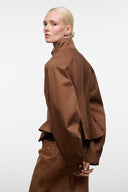 Cigar brown jacket side view with high stand collar and long sleeves; snap front visible