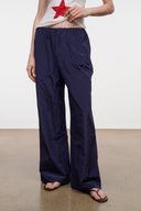 FLO pants in dark navy with wide legs and elastic waist, full side view