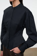 Black long-sleeve top with stand collar and button front, curved hem