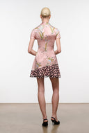 Pink silk dress with short sleeves, floral print, and flared tiered hem