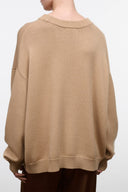 Beige knit sweater with crew neck and dropped shoulders, ribbed hem