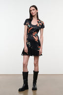 Black silk dress with short sleeves, scoop neck, bird-and-flower tapestry print, ruffled hem