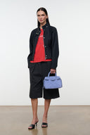 Light blue mini carryall handbag with top handles and front logo panel