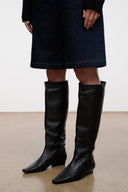 Black knee-high flat pull-on boots with smooth leather-like finish