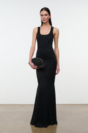Black and silver beaded fringe clutch bag held in front of a black dress