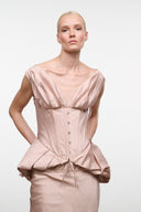 Light rose silk dress with gathered neckline, corset seams, and button front