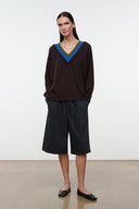 Black flat ballet shoes worn with dark culottes, pointed toe and bow
