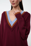 Burgundy V-neck sweater with light blue and brown striped trim, ribbed cuffs, long sleeves