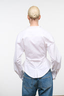 White collared button-up top, back view, long sleeves with fitted waist