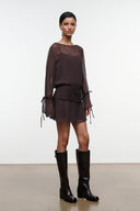 Dark brown sheer long-sleeve mini dress with ruched waist and hanging tie-cuff details.