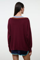 Back view burgundy sweater with V-neck style and striped trim at neckline, long sleeves