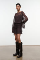 Dark brown sheer long-sleeve mini dress with ruched waist and draped tie cuffs, side view.