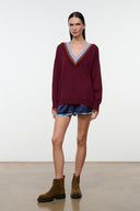 Burgundy V-neck sweater with multicolor trim and relaxed long sleeves