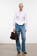 White collared button-up top with long sleeves and hip-length hem
