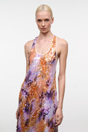 Scoop-neck sleeveless maxi dress; orange, purple, and gold-toned abstract print.
