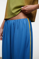Blue wide-leg pants with elastic waistband and yellow side stripe