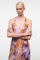 Scoop-neck sleeveless maxi dress in orange, purple, and lilac abstract print.