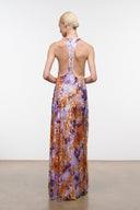 Low-back sleeveless maxi dress with scoop back; orange and purple abstract print.
