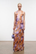 Sleeveless scoop-neck maxi dress with flowing hem; orange and purple abstract print.