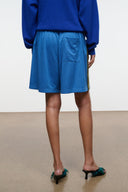 Haskell blue shorts with elastic waistband and side stripe; back pocket detail and logo.