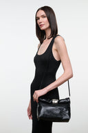 Black snake-textured cuff clutch with silver bar closure and chain strap