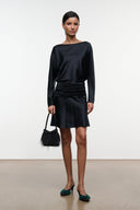 Black silk mini dress with long sleeves and ruched waist, standing full view